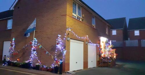 a group of christmas trees on the side of a building at Marina & Seagulls in East Cowes