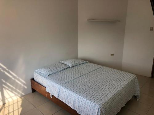 a bedroom with a bed in a white room at Estela, habitación privada de Flor de Lis Beach House in Playas