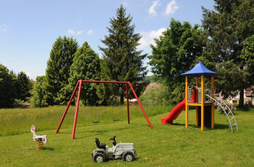 a group of playground equipment in a field at Hotel Gasthof Jägerhaus in Sankt Peter