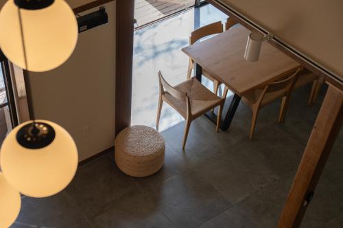 a room with a table and chairs and lights at プライベートリゾート犬の日 in Hakone