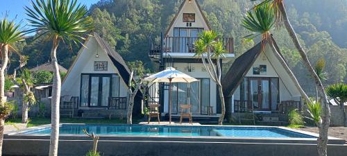 a house with a swimming pool in front of a house at Batur Homestay and Lodge in Bangli
