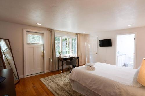 a bedroom with a white bed and a desk at Single Family,3 Bed, 3 Bath,harvard, Mit,hospitals in Cambridge