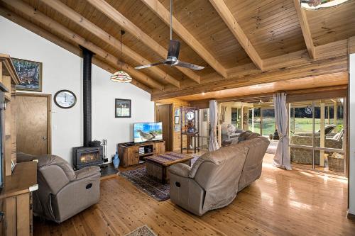a living room with couches and a tv and a fireplace at Valla Beach Top Spot in Valla