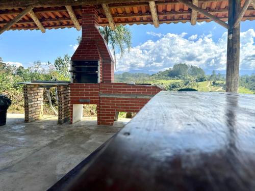 a brick oven on top of a patio at CABANAS BELVEDERE SERRA DO RiO DO RASTRO in Lauro Müller