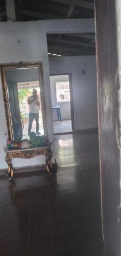 a person taking a picture in a mirror at Ortiz Hospedaje Ometepe in Altagracia