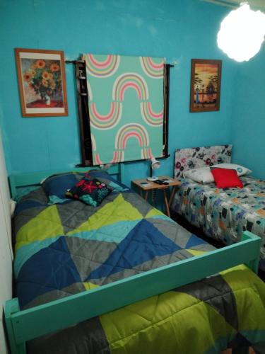 a bedroom with two beds and blue walls at B&B Patagonia Dreams in Puerto Montt