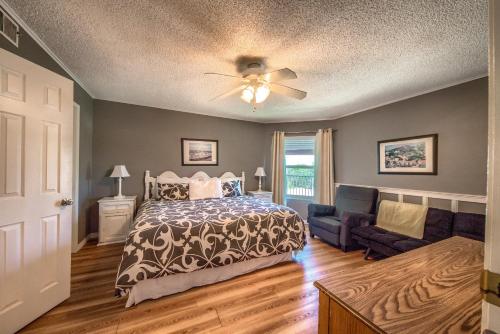 a bedroom with a bed and a couch and a ceiling fan at Sweet Retreat RRC A203 in New Braunfels