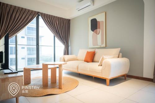 a living room with a couch and a table at K Avenue by Pinstay in Donggongon