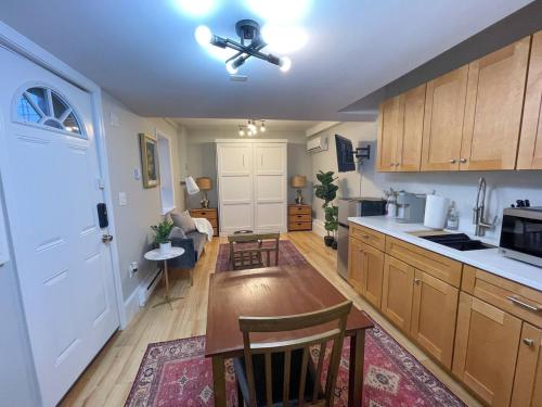 a kitchen with wooden cabinets and a ceiling fan at Renovated Studio, Near Hospitals, Mbta in Boston