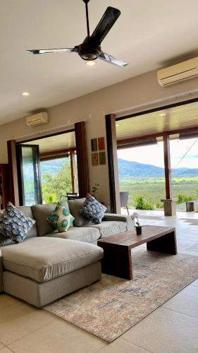 a living room with a couch and a table at Ranis Lodge in Kampung Padang Masirat
