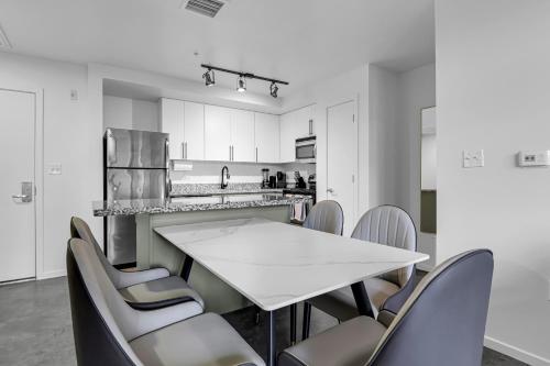 a kitchen with a white table and chairs at The Nomad Roosevelt in Phoenix
