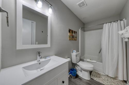 a white bathroom with a sink and a toilet at 1408 Perrin Dr, Unit A - Ocean Walk Sleeps 8 in Myrtle Beach