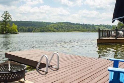 a dock on a lake with a grill on it at Colgate Cabin #6 in Hamilton