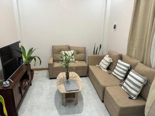 ein Wohnzimmer mit einem Sofa und einem TV in der Unterkunft Comfy staycation I in Sorsogon City in Sorsogon