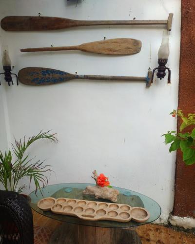 a glass table with a bowl of water and two wooden spoons at Beach House at Carolina del Mar in Samboan