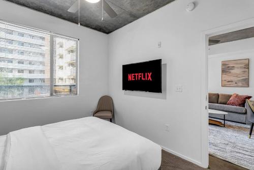 a bedroom with a bed and a tv on the wall at The Nomad Roosevelt in Phoenix