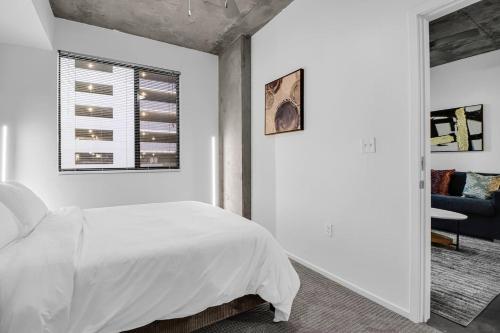 a white bedroom with a bed and a window at The Nomad Roosevelt in Phoenix