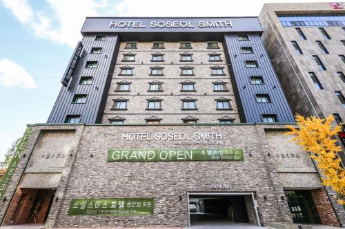 a building with a sign that reads grand open at Hotel Soseol Smith in Cheonan