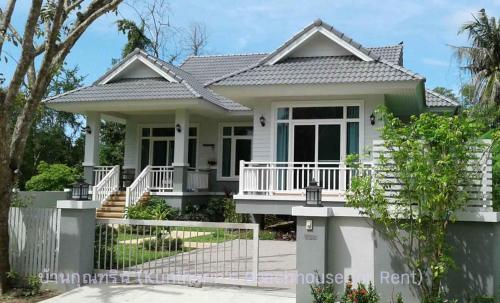 a house with a white fence in front of it at Resort house - 2 min walk to the beach in Ban Krut