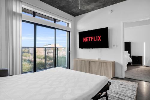 a bedroom with a bed and a tv on a wall at The Nomad Roosevelt in Phoenix