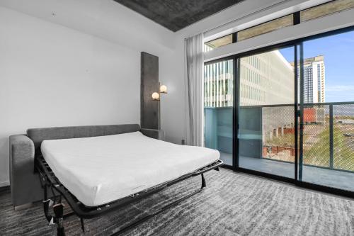 a hospital room with a bed and a large window at The Nomad Roosevelt in Phoenix