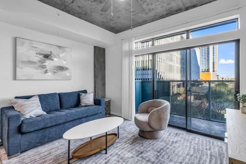 a living room with a blue couch and a table at The Nomad Roosevelt in Phoenix