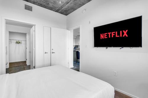 a bedroom with a bed with a netflix sign on the wall at The Nomad Roosevelt in Phoenix