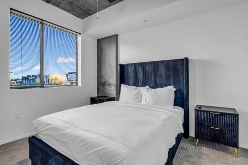 a bedroom with a large bed and a large window at The Nomad Roosevelt in Phoenix