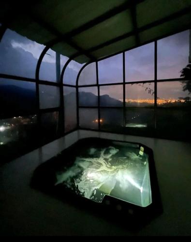 a jacuzzi tub in a room with a window at La Villa The View in Pance