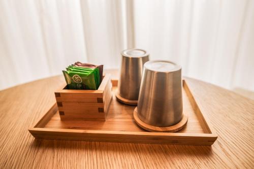 a wooden tray with two speakers on a table at Wayfarer Kyoto Shijo in Kyoto
