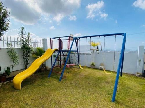 a playground with a slide in a yard at The Stunning Views here are beyond description ! in Candulawan