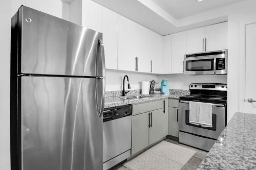 a kitchen with a stainless steel refrigerator and appliances at The Nomad Roosevelt in Phoenix