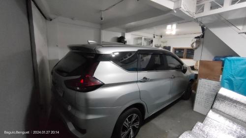 a small silver car parked in a garage at Kochimoto Guesthouse in Baguio