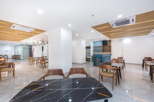 a dining room with a table and some chairs at Diamond Sea Hotel in Vung Tau