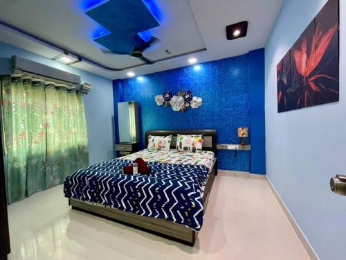 a bedroom with a zebra print bed with blue walls at Beautiful 2bhk near Begumpet in Hyderabad
