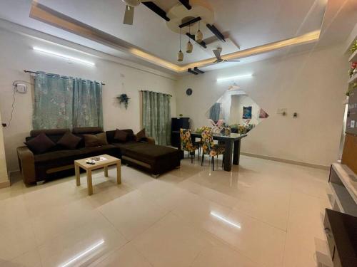 Beautiful 2bhk near Begumpet في حيدر أباد: غرفة معيشة مع أريكة وطاولة