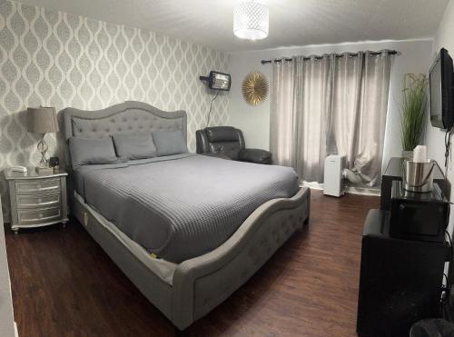 a bedroom with a bed and a television in it at The Village Inn Hotel in Milwaukee