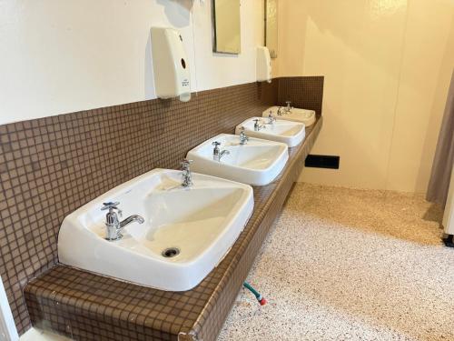 a bathroom with two sinks and a mirror at The Crossing Lodge & Backpackers in National Park