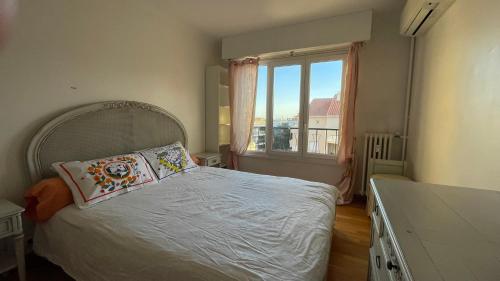 une chambre avec un lit et une grande fenêtre dans l'établissement 3 Pieces Agreable, Confortable, à Cannes