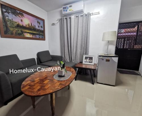 a living room with a couch and a table at Homelux Transient House in Cauayan City