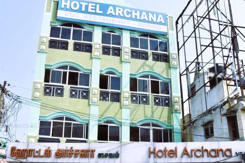 a hotel apartment building with a sign on it at Hotel Archana in Madurai