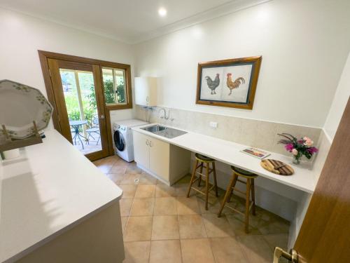 a kitchen with a sink and a counter top at Barossa Garden Homestay in Williamstown