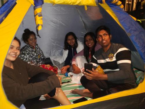 un groupe de personnes assises dans une tente dans l'établissement Eagles view Gongala, à Deniyaya
