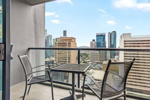 a table and chairs on a balcony with a view at City Centre! 1Bed/1Bath/Study/1Car/Balcony ~ CBD in Brisbane