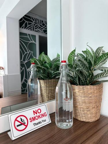 a no smoking sign and two bottles on a table at Tuấn Ninh Hotel I in Con Dao