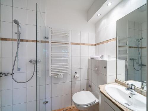 a bathroom with a shower and a toilet and a sink at Beach house Dune 19 - happiness in Neuhaus