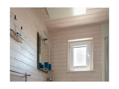 a bathroom with a window and a sink at Houseboat Harmony in Stralsund