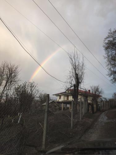 a rainbow in the sky over a house at Village Villa with National Park View in Librazhd