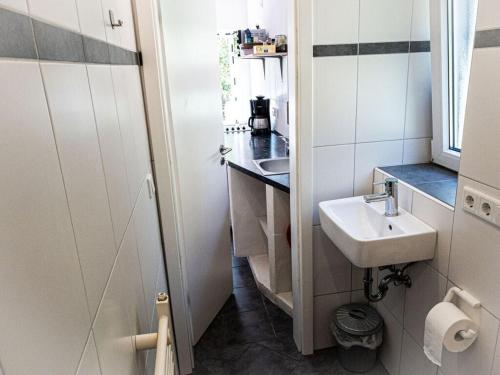 a small bathroom with a sink and a mirror at Borkum Freedom 1 in Borkum