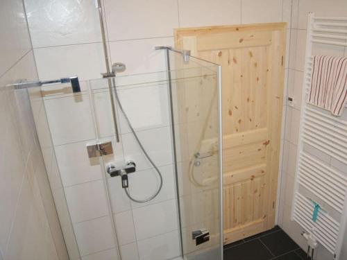 a shower with a glass door in a bathroom at Rügen Apartment Waterview in Buschvitz